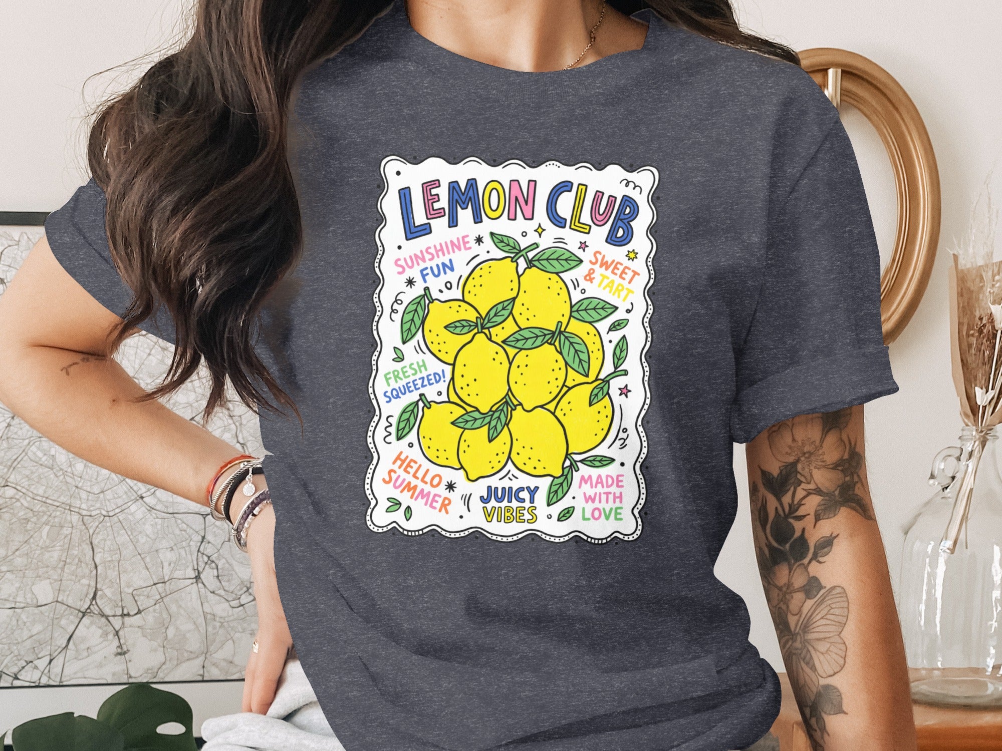 T-shirt graphic with "Lemon Club" text and cluster of vibrant yellow lemons.