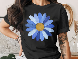 Black t-shirt with a large blue daisy graphic with a yellow center.