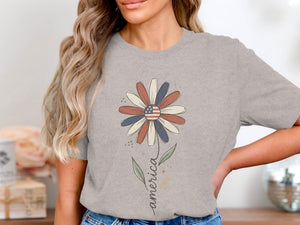 Grey t-shirt with a daisy graphic featuring an American flag center and the word "america".