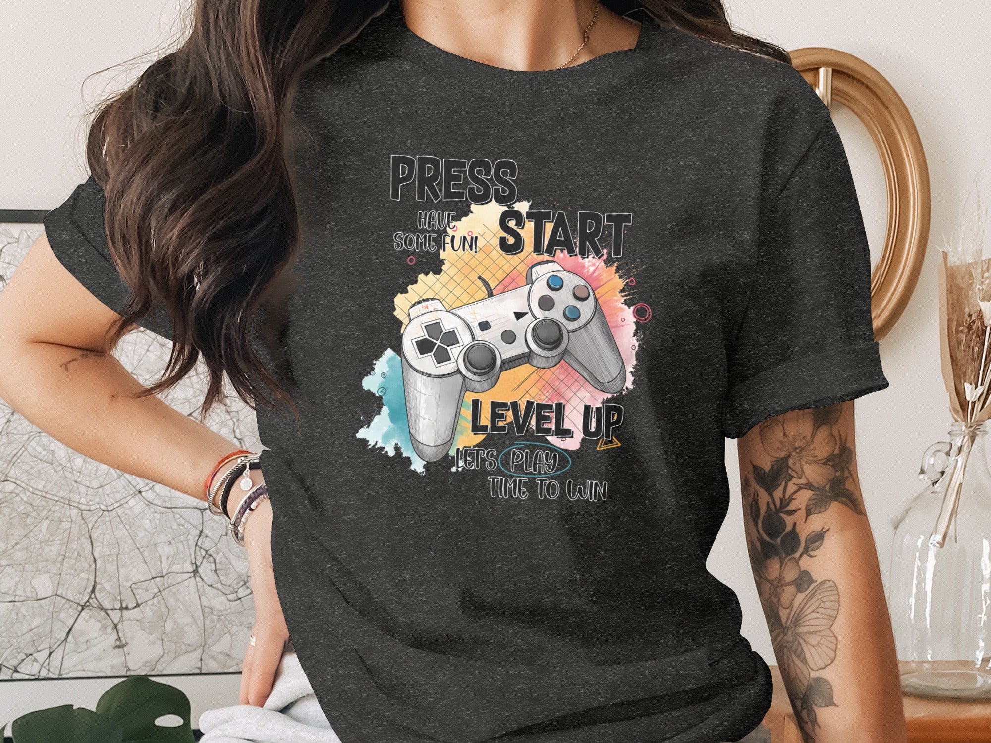 Dark t-shirt with "Press Start", "Level Up", "Let's Play", "Time to Win" and game controller graphic.