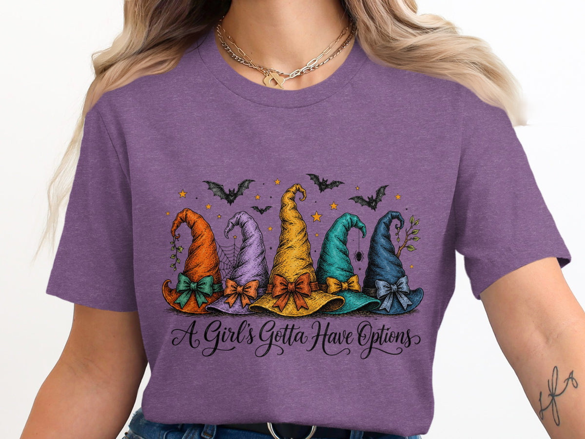 Five colorful witch hats with bows and Halloween accents, with text "A Girl's Gotta Have Options".