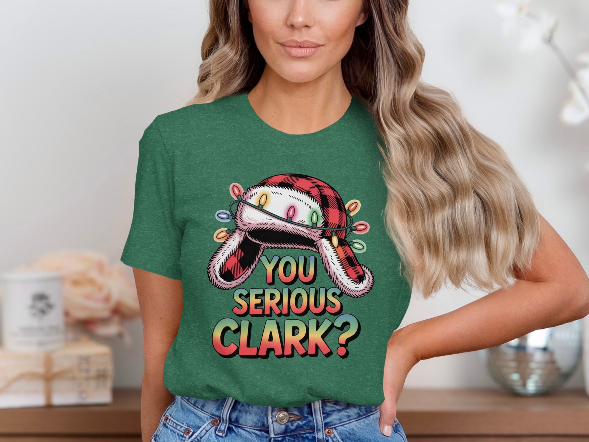 Green t-shirt with a graphic of a fuzzy hat with Christmas lights and text "YOU SERIOUS CLARK?".