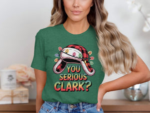 Green t-shirt with a graphic of a fuzzy hat with Christmas lights and text "YOU SERIOUS CLARK?".