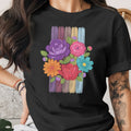 Black t-shirt with a colorful floral bouquet design on a striped background.