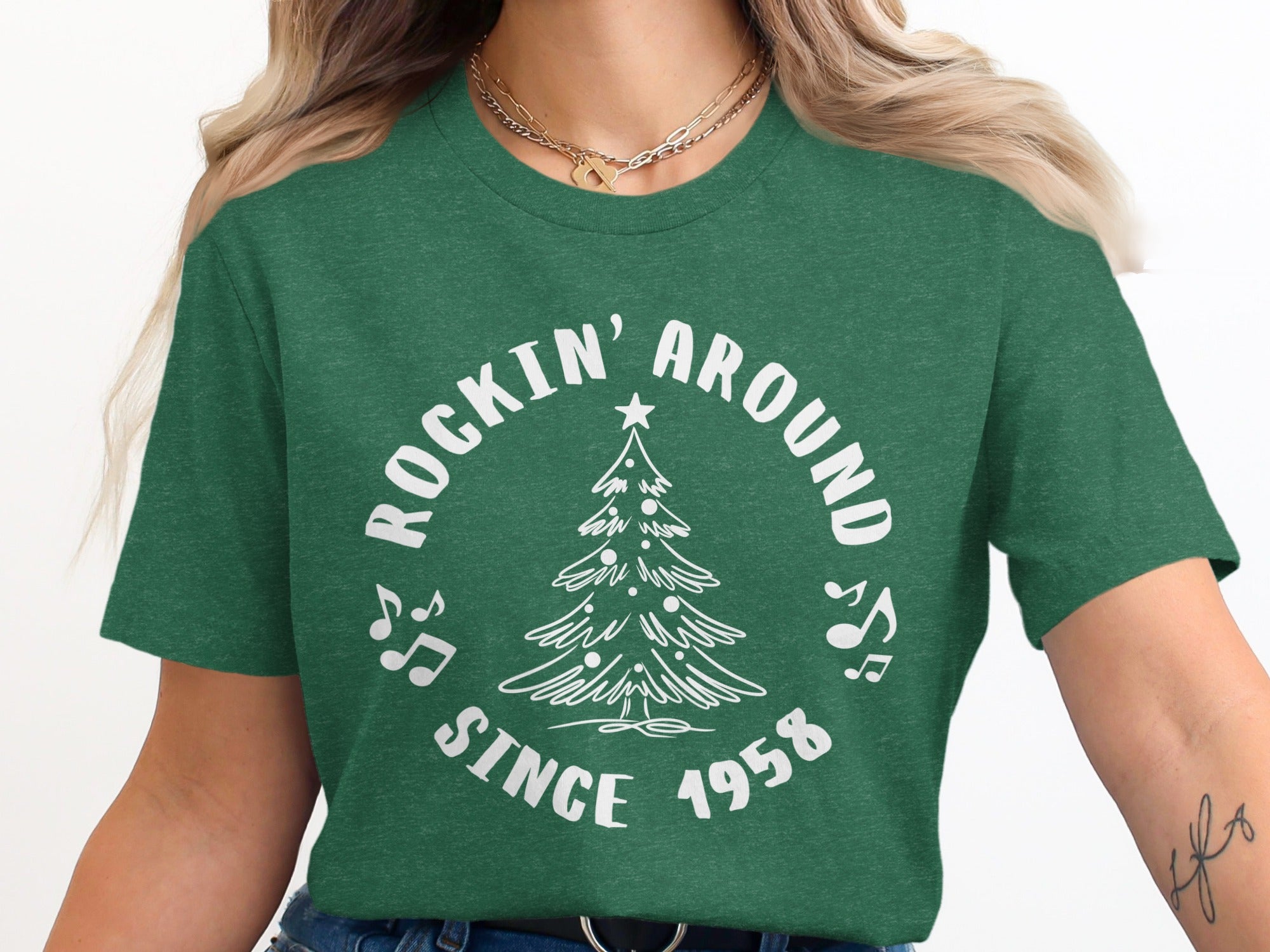 Green t-shirt with white text and Christmas tree graphic "Rockin' Around Since 1958".