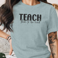 Light blue t-shirt with black text "TEACH them to be kind"