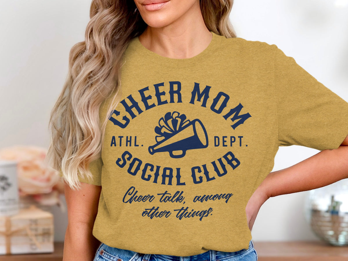 Gold t-shirt with navy blue text and megaphone graphic reading "Cheer Mom Social Club".