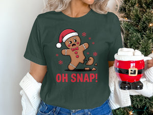 Gingerbread man with "OH SNAP!" text, wearing Santa hat, on dark green shirt.