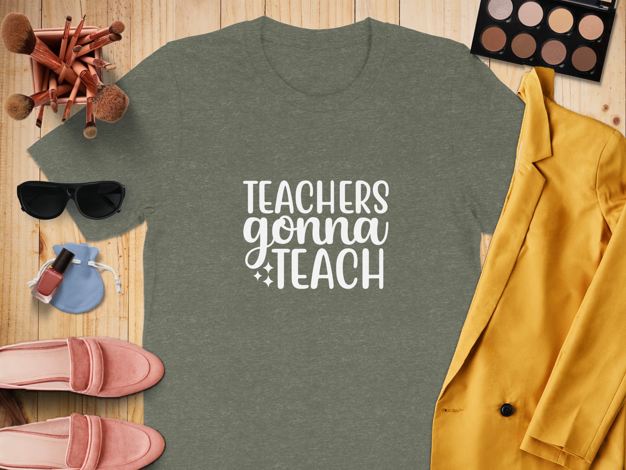 Olive t-shirt with white text "Teachers Gonna Teach" surrounded by accessories.