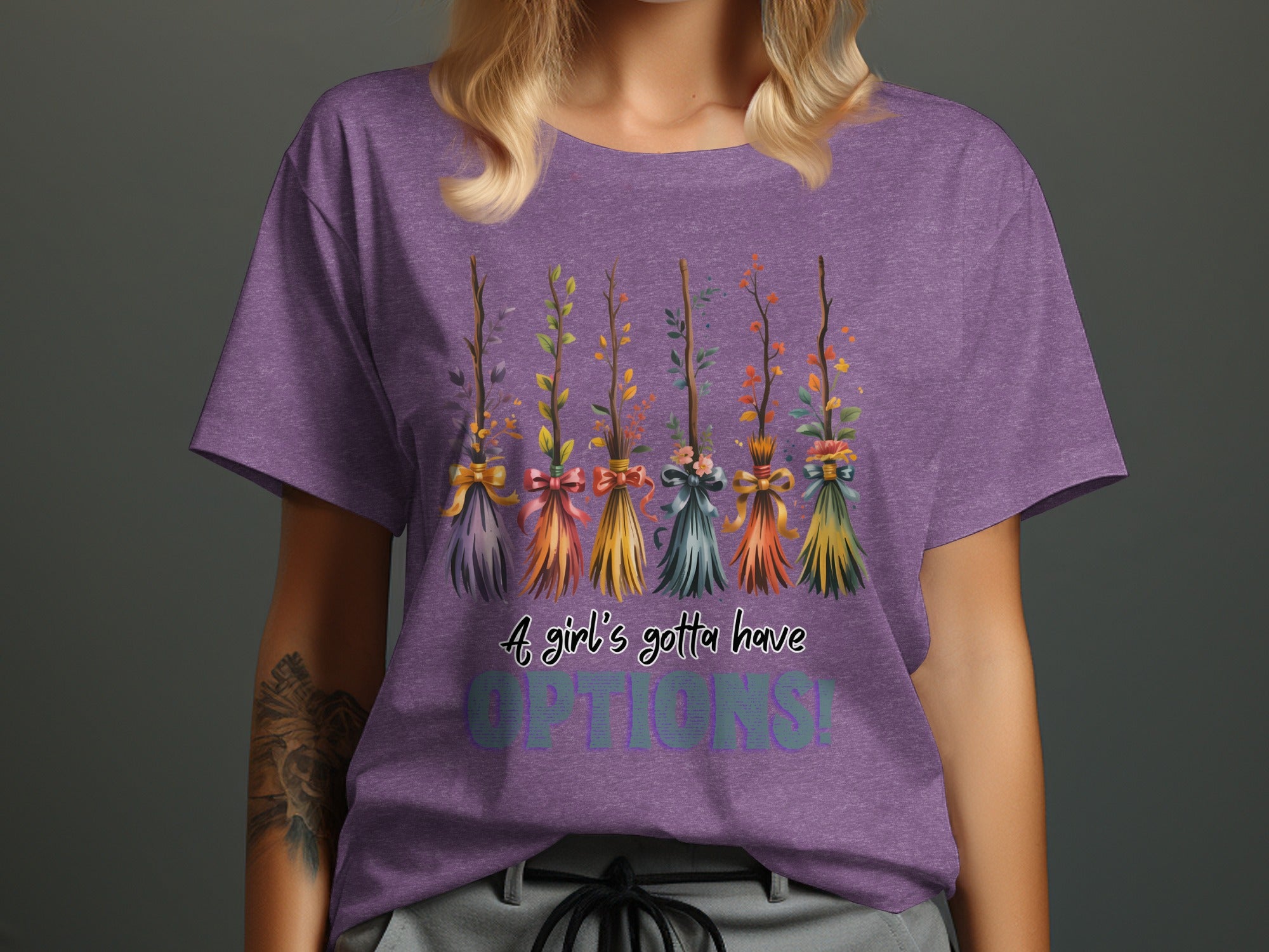 Purple t-shirt with five decorative brooms and text "A girl's gotta have OPTIONS!".