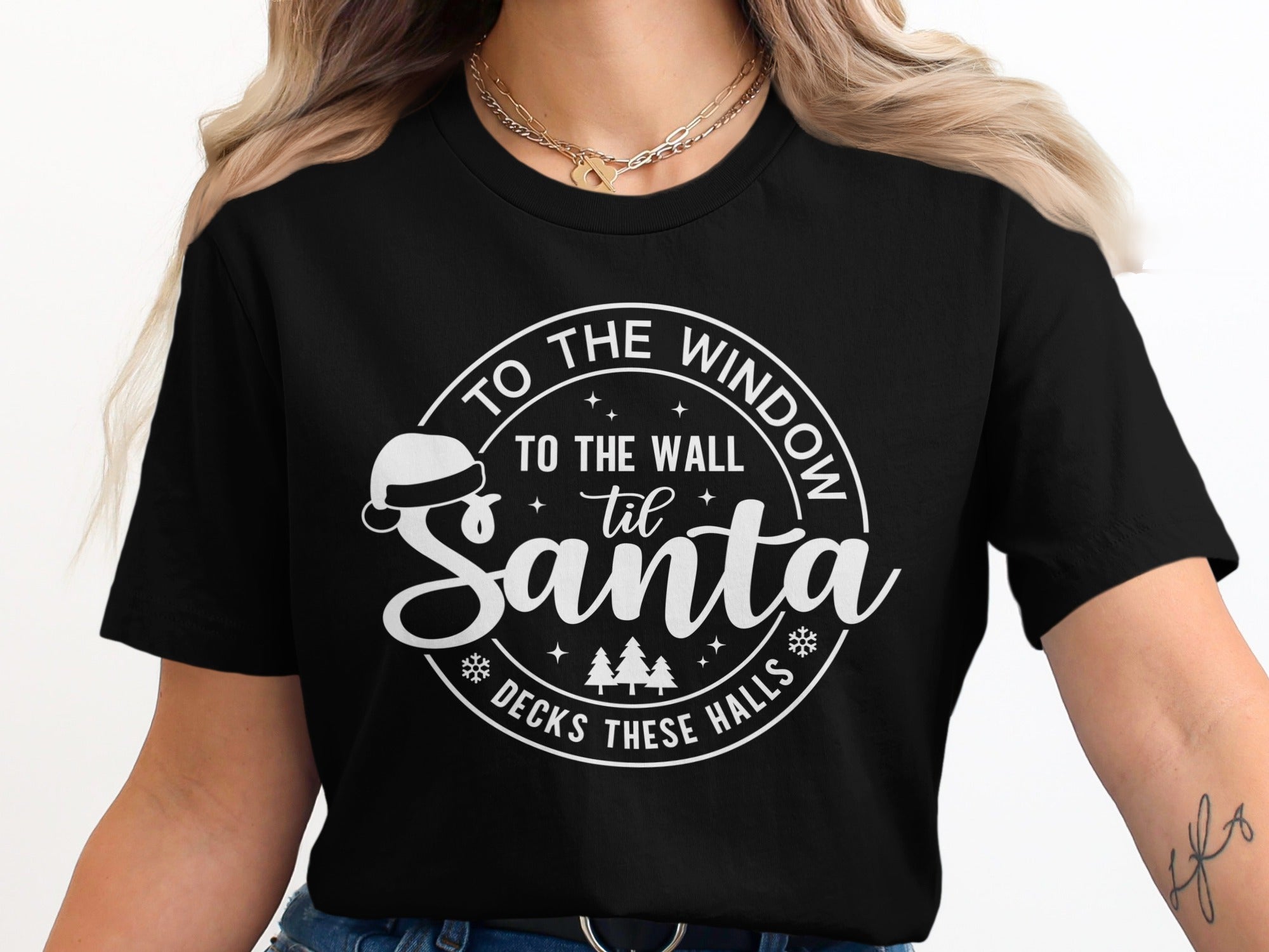 Black t-shirt with white graphic: "To the wall til Santa decks these halls"