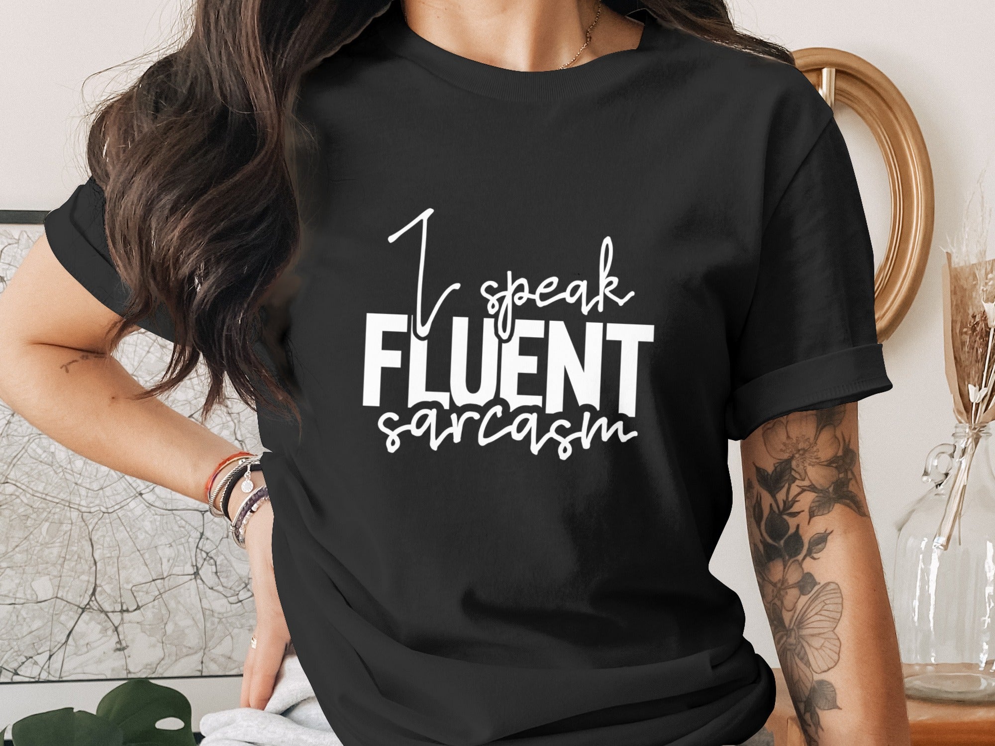 Black t-shirt with white text reading "I speak FLUENT sarcasm."