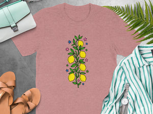 Pink t-shirt with a vertical lemon branch and star design.