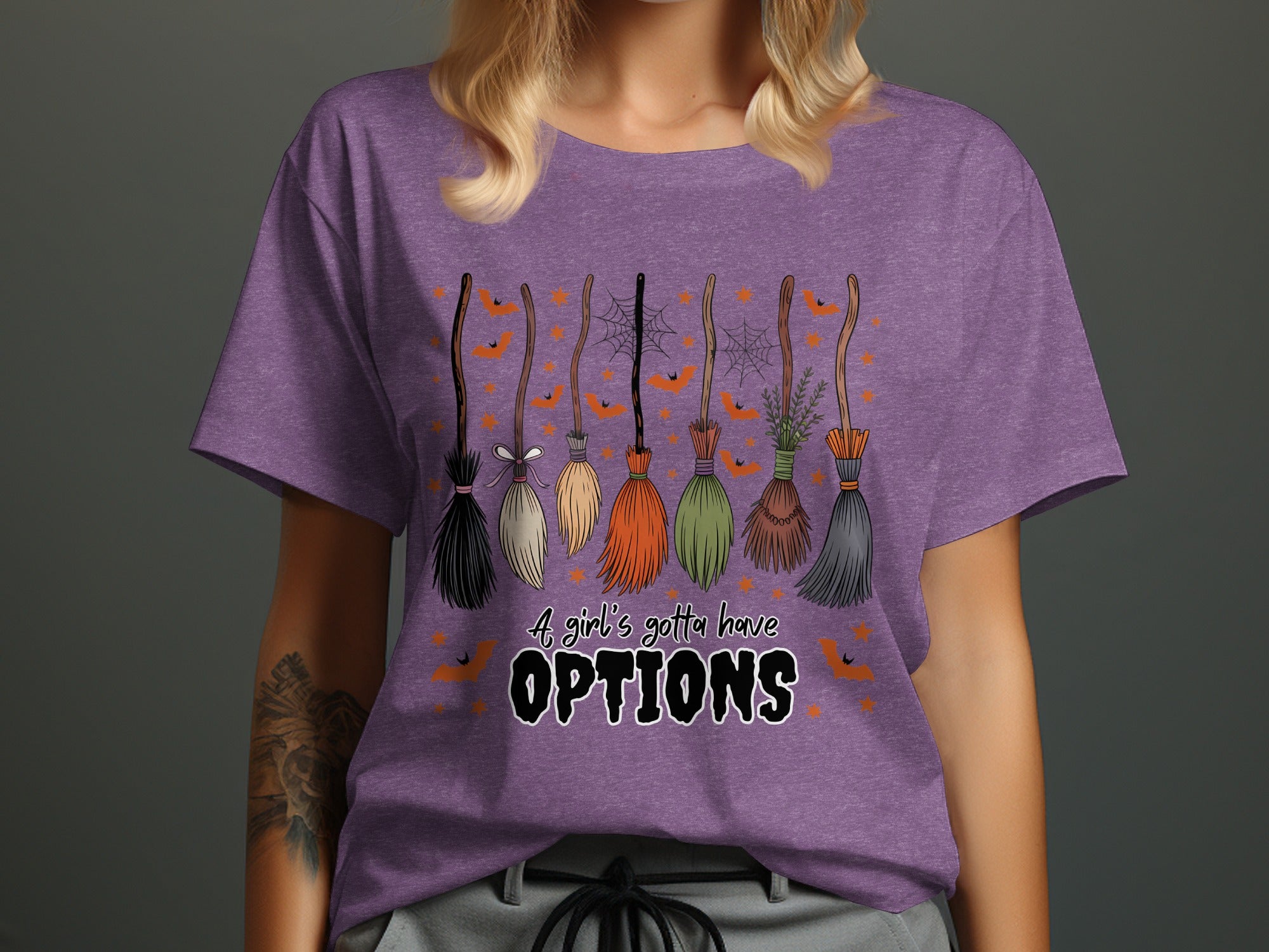 Graphic tee with assorted brooms and text that reads "A girl's gotta have OPTIONS."