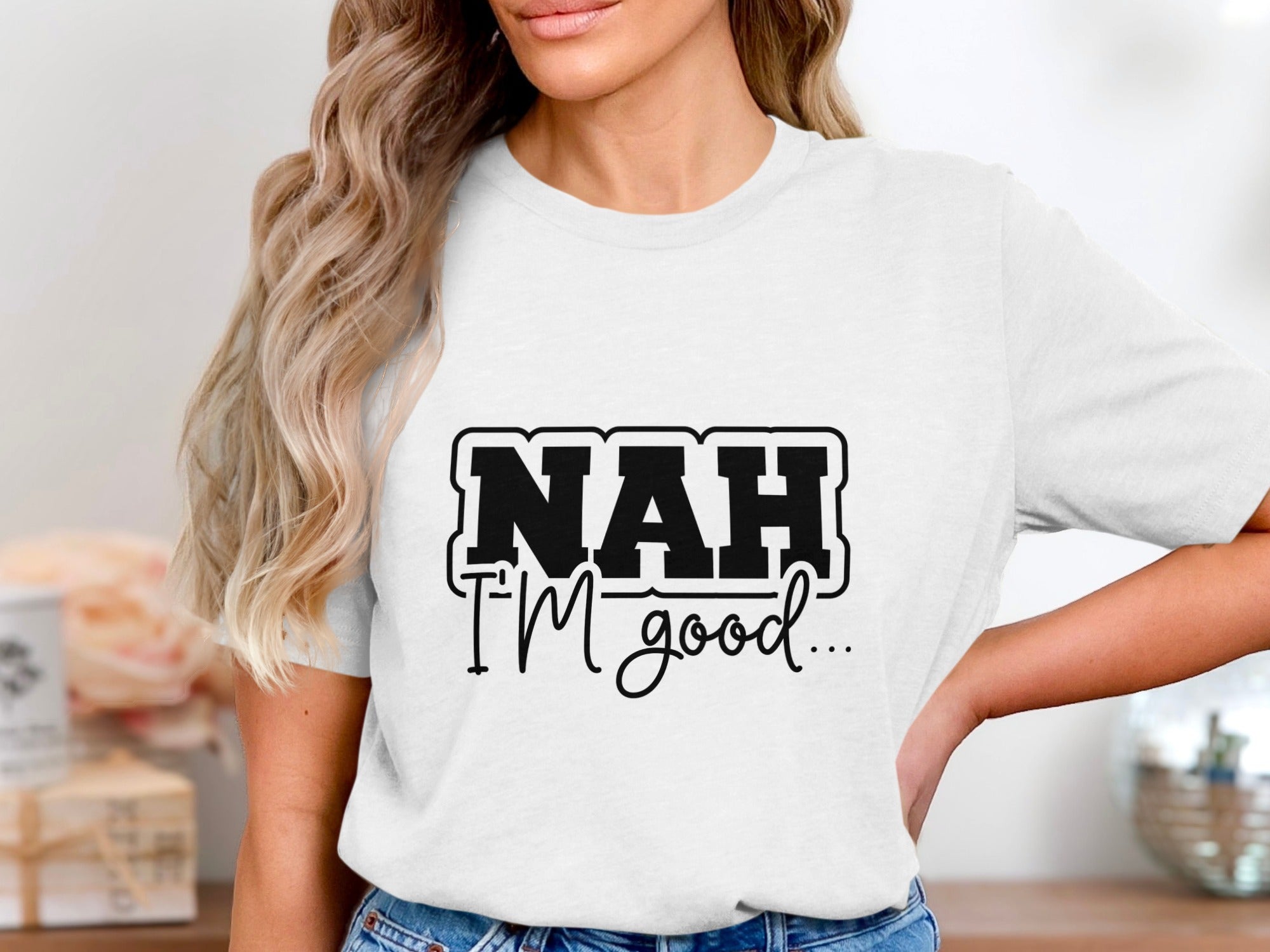White t-shirt with "NAH I'M good..." text graphic.