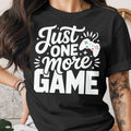 Black t-shirt with white text "Just ONE more GAME" and a game controller graphic.