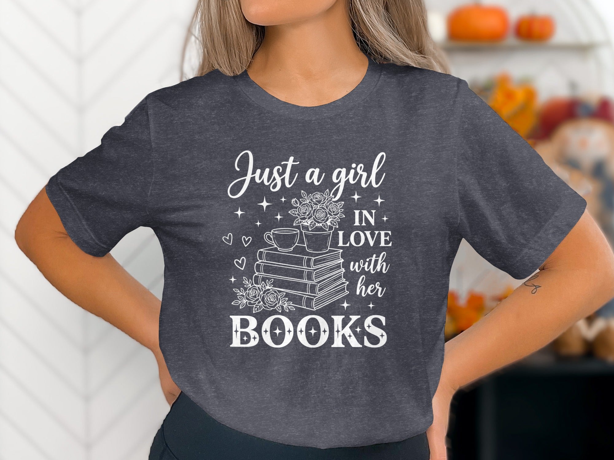 Dark grey t-shirt with white text "Just a girl IN LOVE with her BOOKS" and book graphic.
