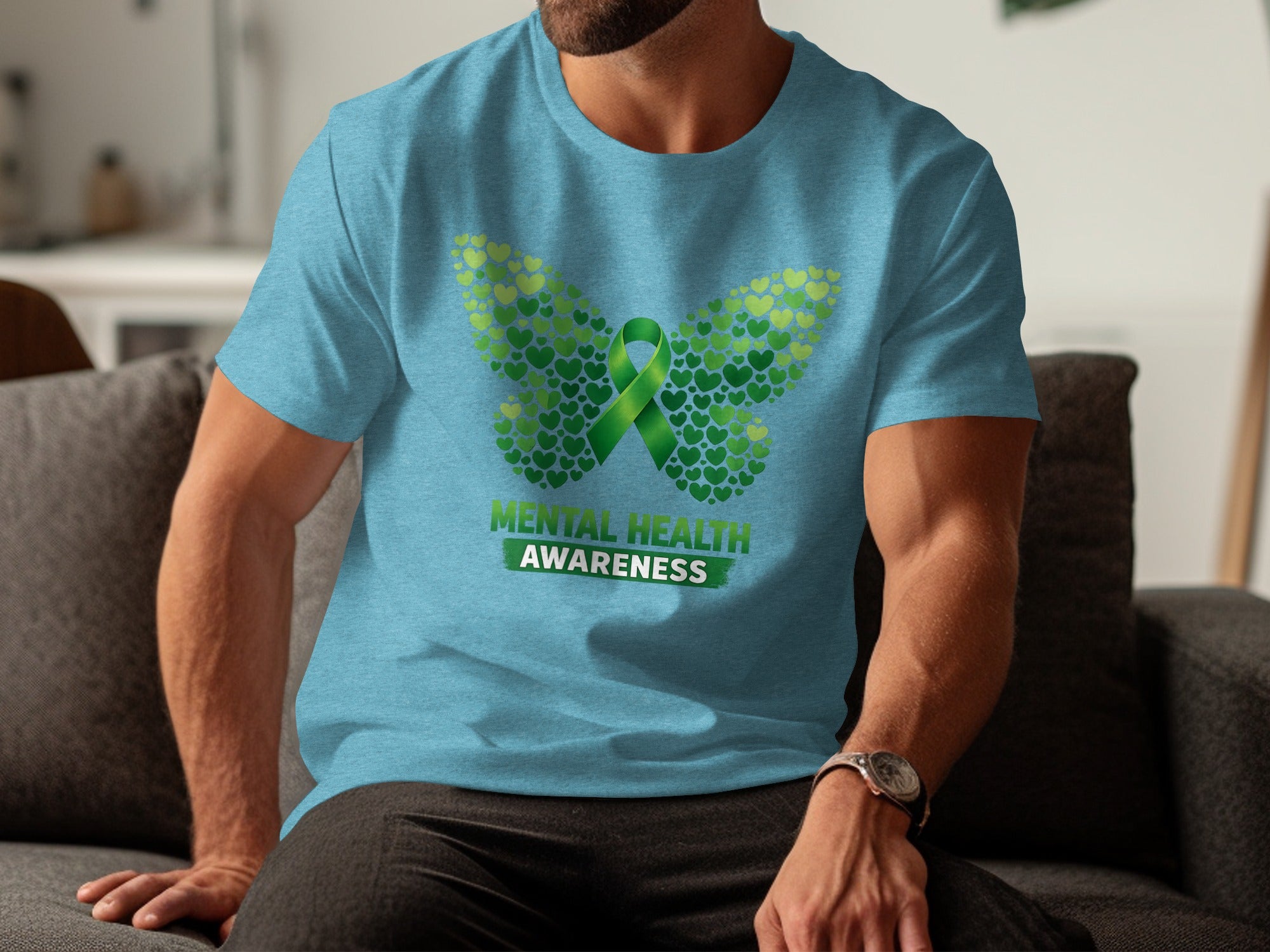 Light blue t-shirt with butterfly design made of green hearts and "Mental Health Awareness" text.