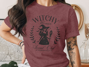 Maroon t-shirt with "Witchy Woman Social Club" graphic and witch illustration.