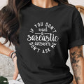 Black t-shirt with white text: "If you don't want a sarcastic answer, don't ask me."