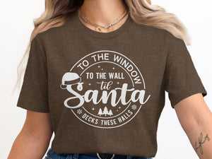 Brown t-shirt with white text: "To the window, to the wall 'til Santa decks these halls."