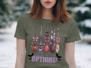 Halloween brooms with pumpkin, bats, and ghosts. Text reads "A girl's gotta have OPTIONS!".