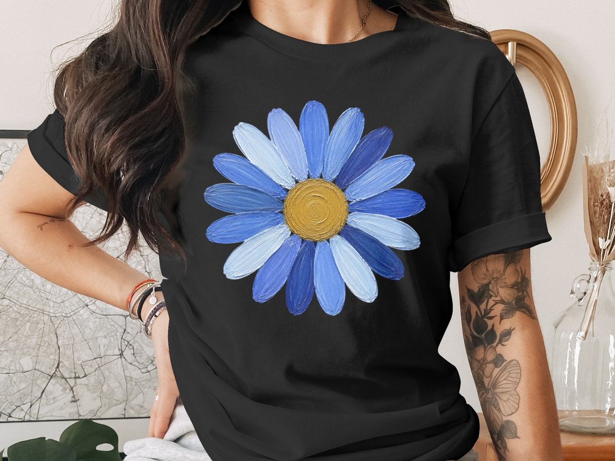 Black t-shirt with blue and yellow painted daisy graphic.