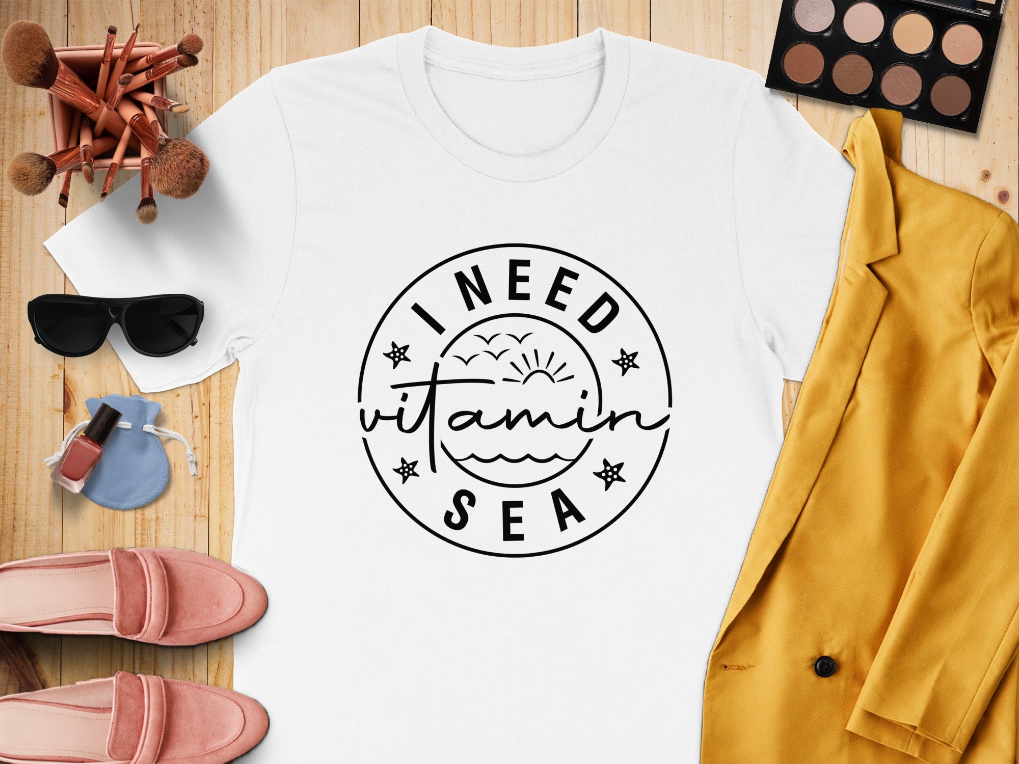 White t-shirt with "I NEED vitamin SEA" graphic and beach theme accessories.