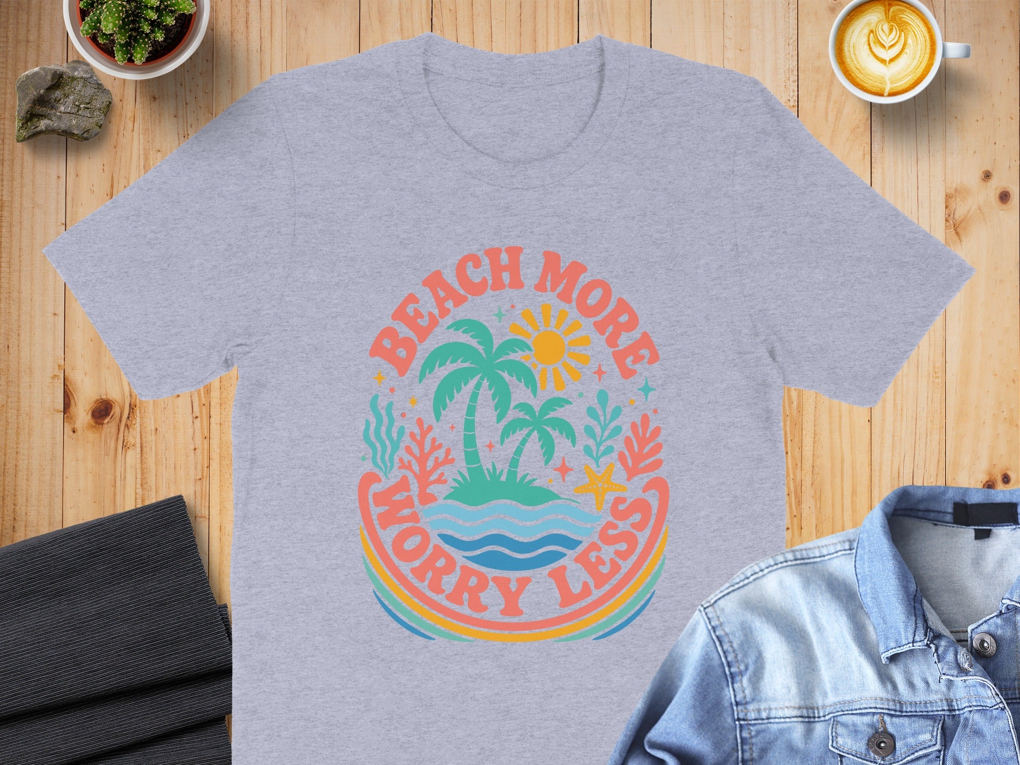 Light grey t-shirt with "Beach More Worry Less" graphic featuring palm trees and ocean scene.