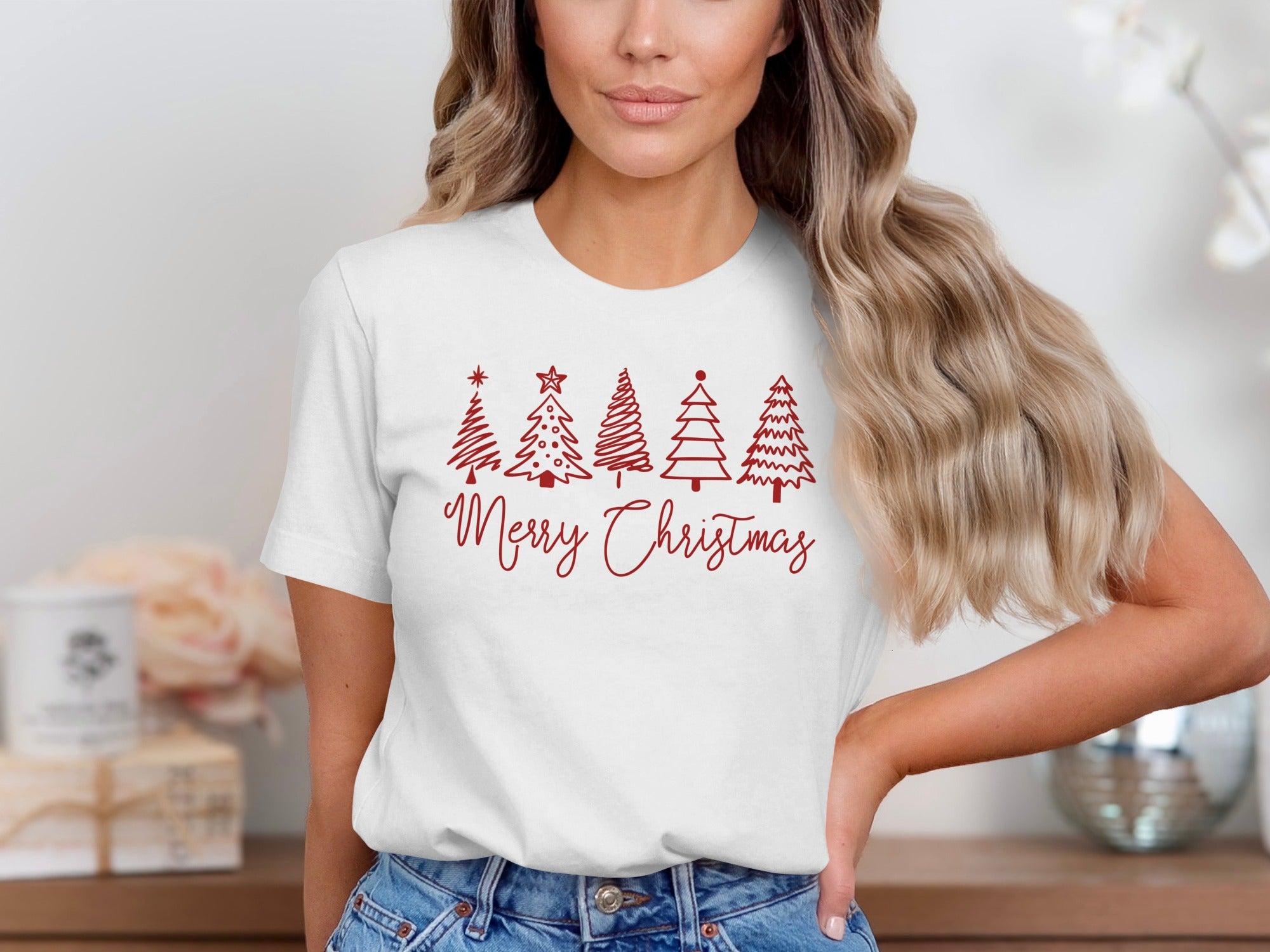 White t-shirt with red Christmas trees and "Merry Christmas" text graphic.