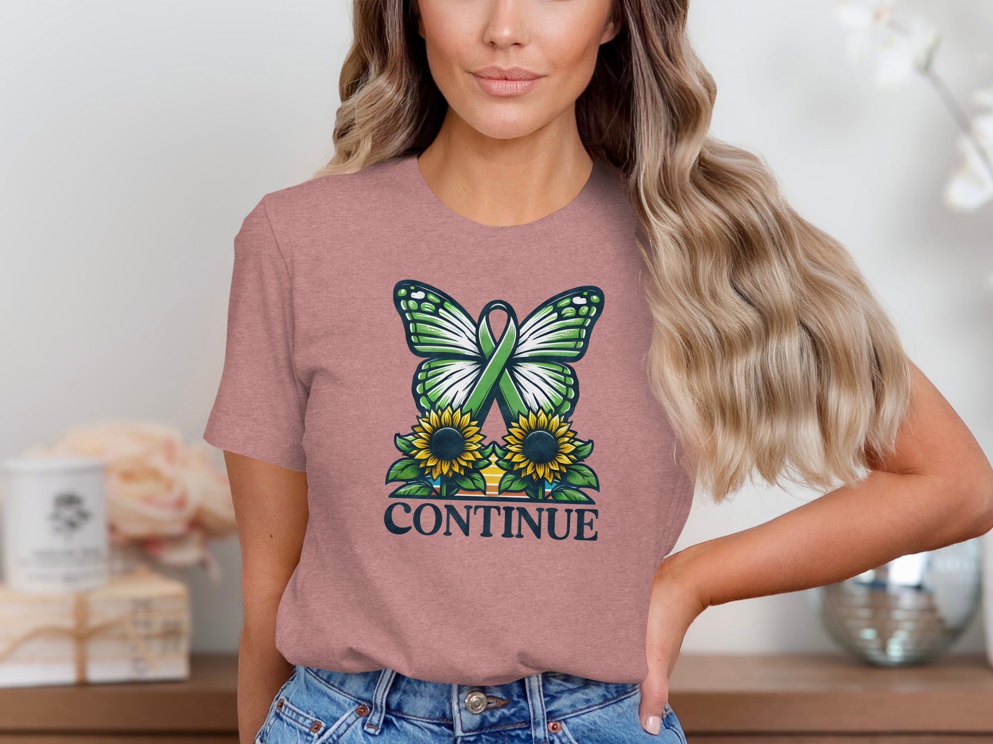 Butterfly and sunflowers with green ribbon, text "CONTINUE" on pink t-shirt.