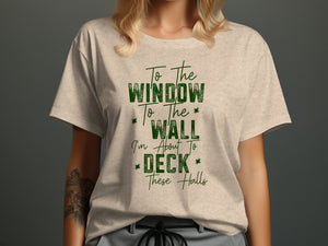 Light beige t-shirt with green text "To The Window To The Wall I'm About To Deck These Halls."