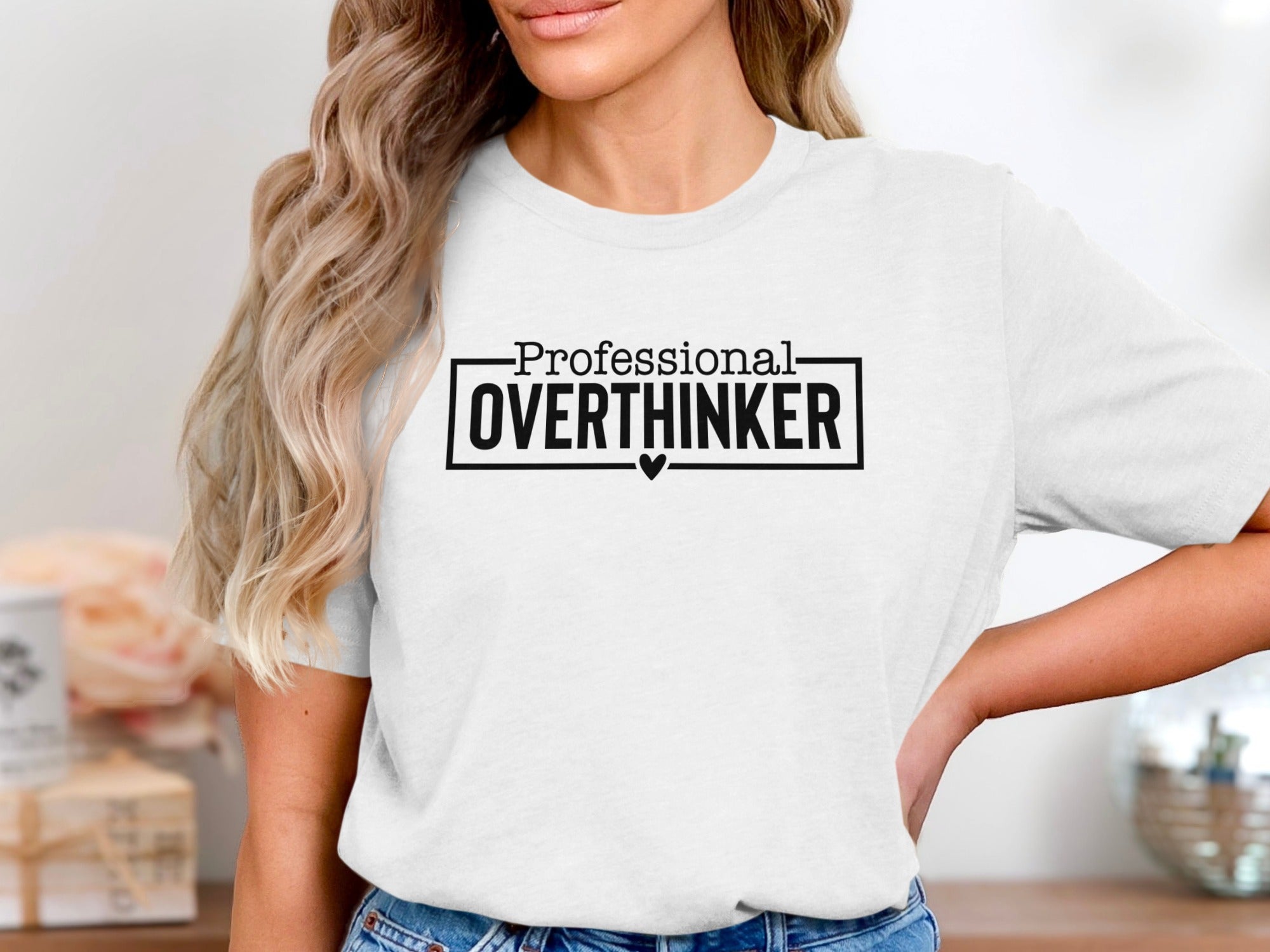 White t-shirt with black text that reads "Professional OVERTHINKER" with a small heart.