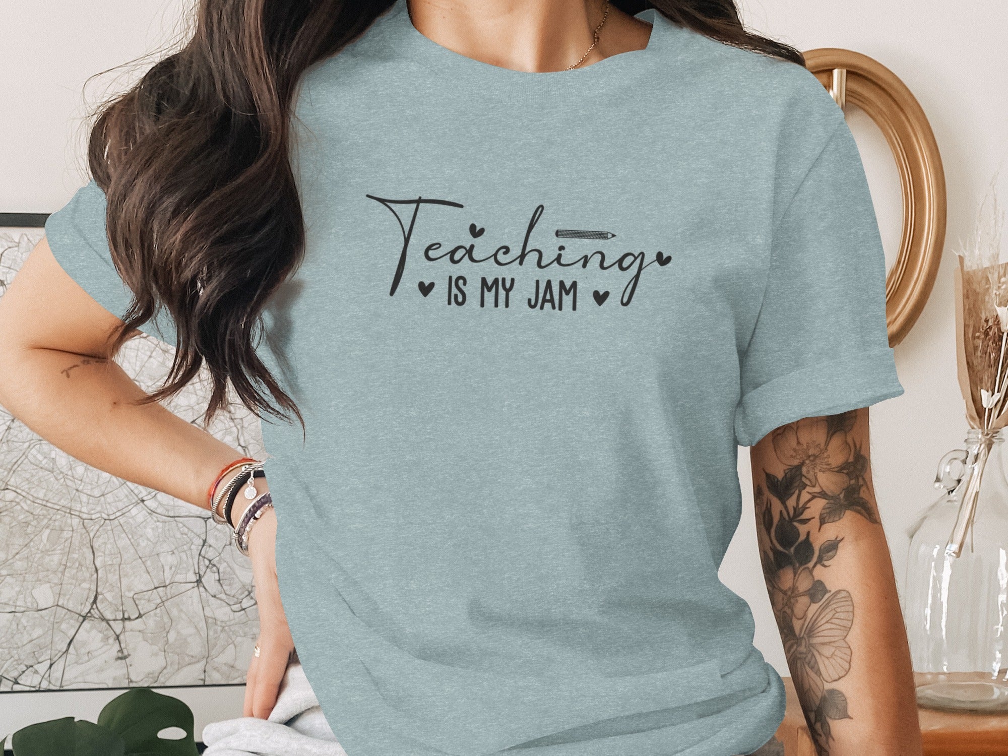 Light blue t-shirt with black text "Teaching IS MY JAM" and a pencil.