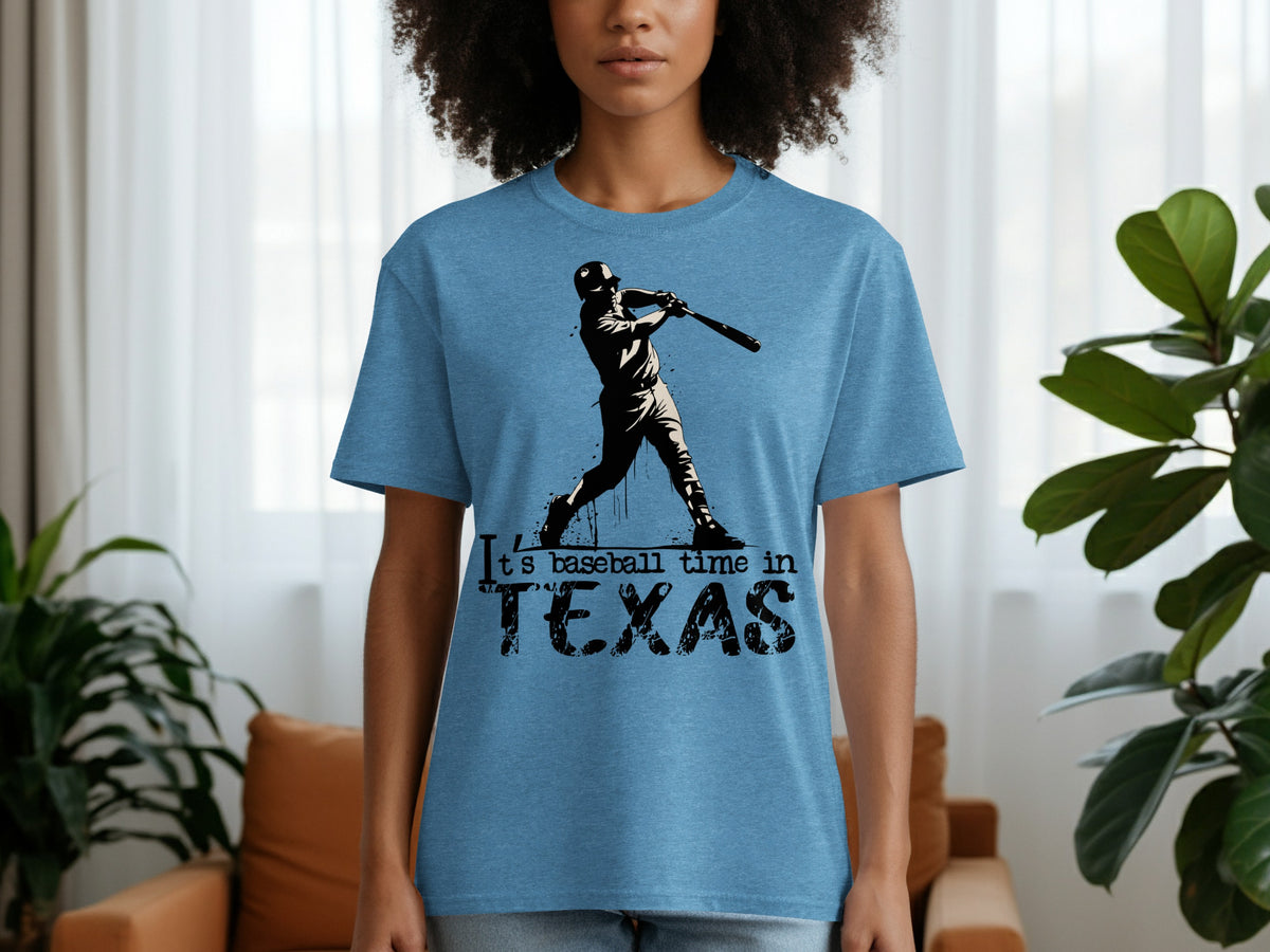 Blue t-shirt with a black graphic of a baseball player and text "It's baseball time in TEXAS".