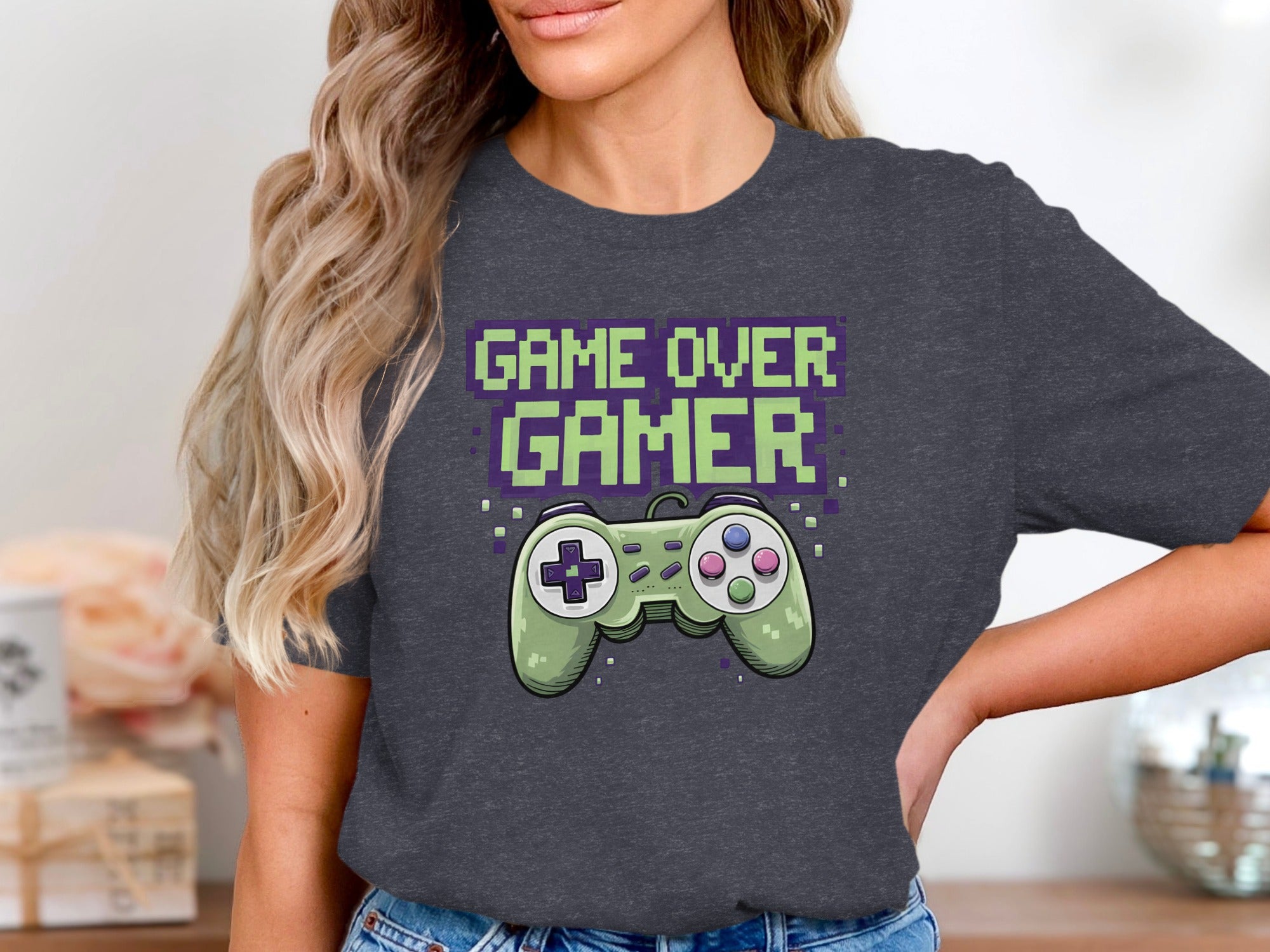 Dark grey t-shirt with pixelated text "GAME OVER GAMER" and a light green video game controller.