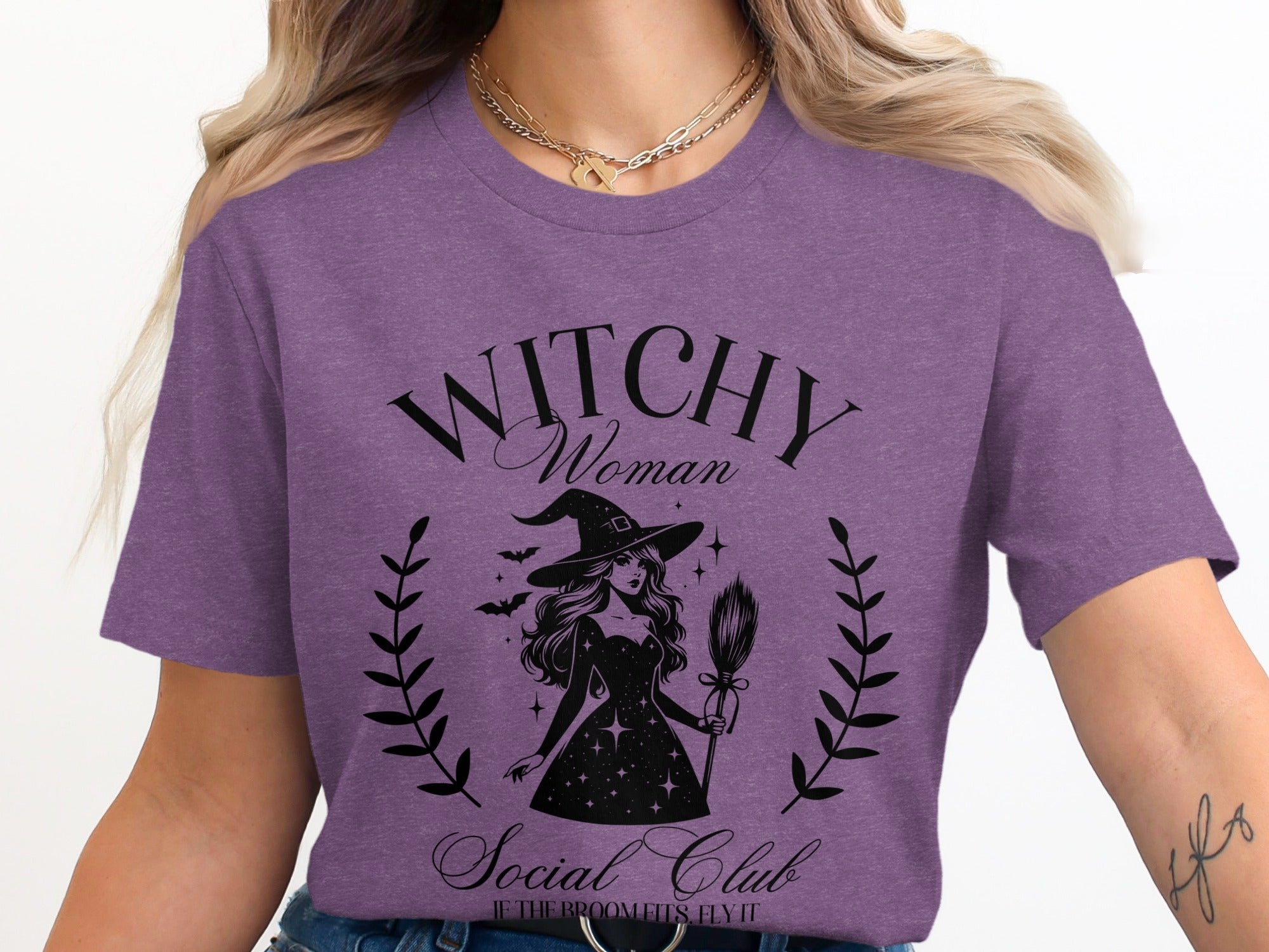 Witchy Woman Social Club graphic on purple t-shirt with witch illustration.