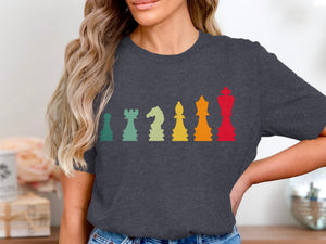 Dark t-shirt with a vintage-style graphic of multicolored chess pieces in a row.