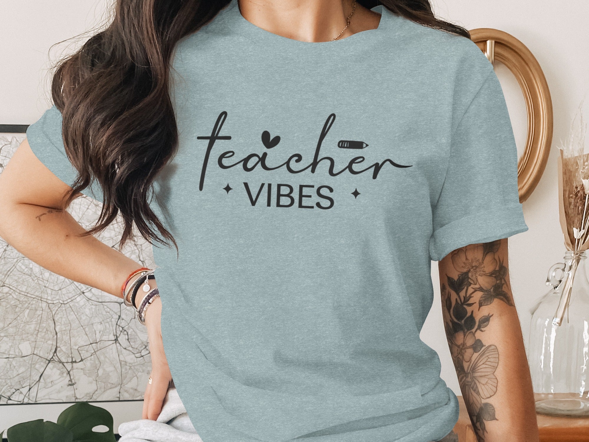 Light blue t-shirt with black text: "teacher VIBES" and subtle graphics.