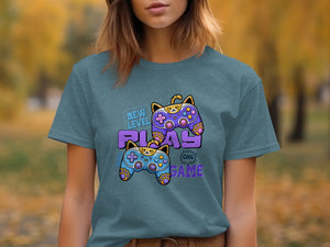 T-shirt graphic with cat-themed game controllers and text "New Level Play Cool Game."