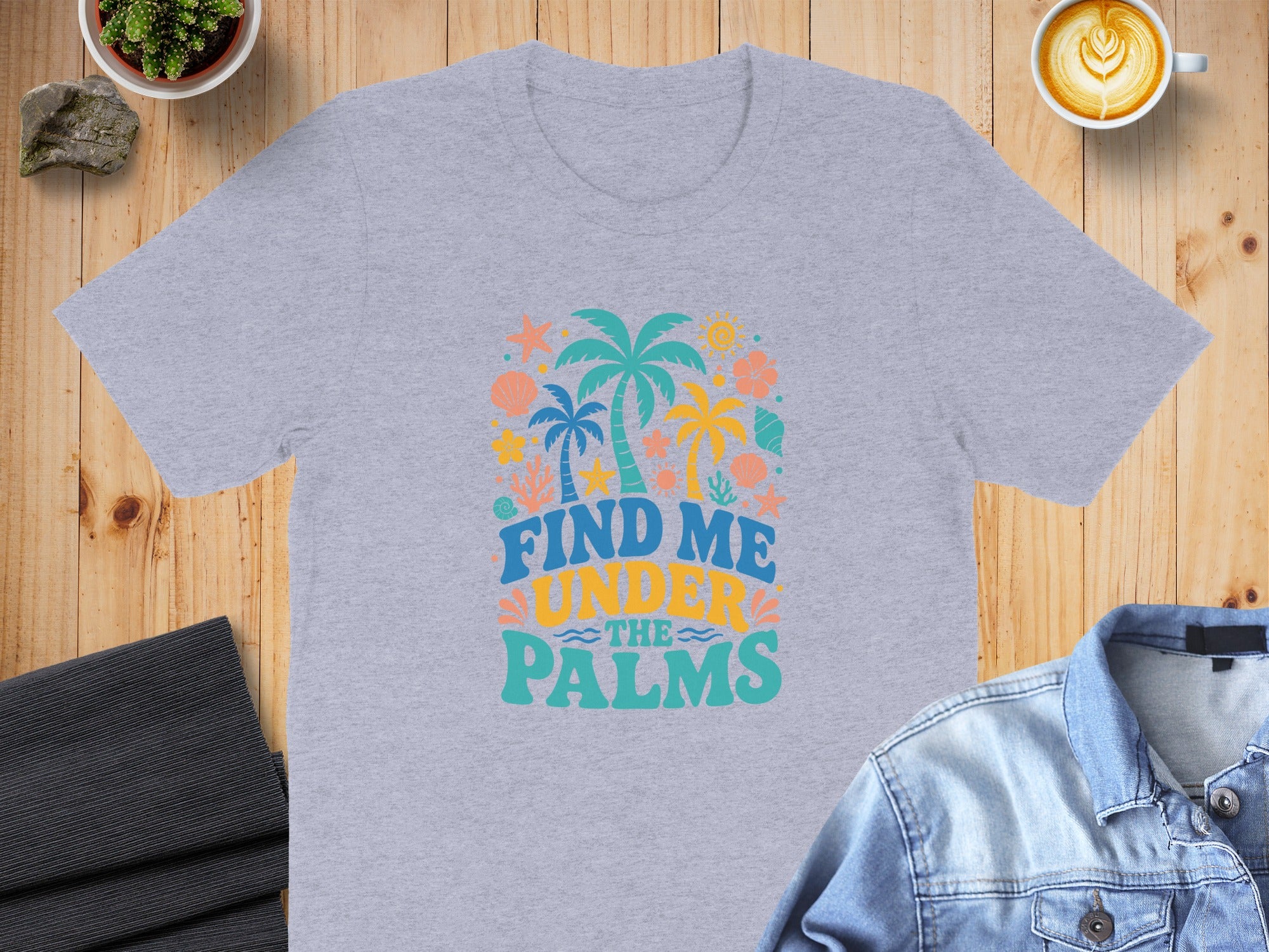 Light gray t-shirt with "Find Me Under The Palms" text and tropical graphics.