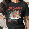 McCallister's Home Security graphic on a black t-shirt with a snowy house.