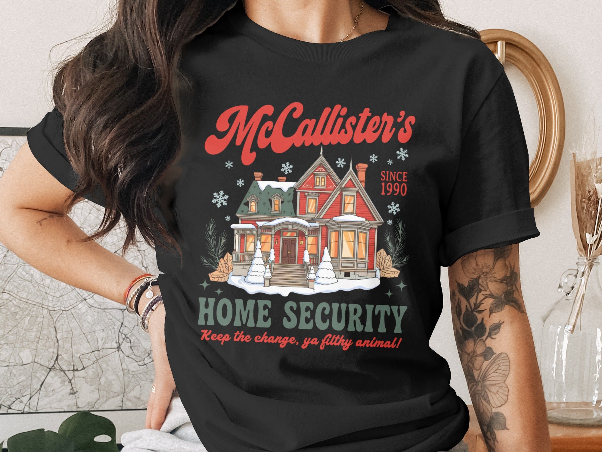 McCallister's Home Security graphic on a black t-shirt with a snowy house.