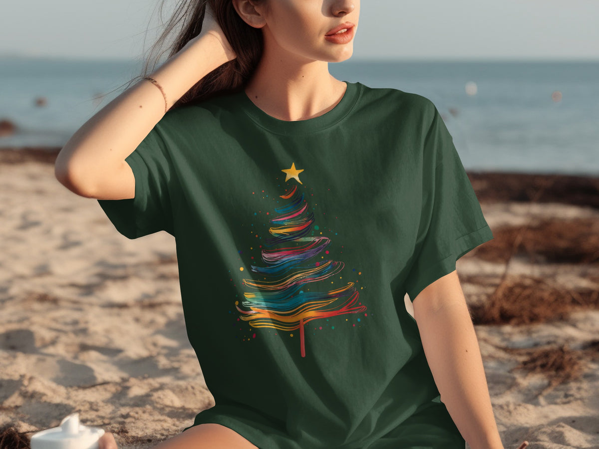 Dark green t-shirt with a colorful abstract Christmas tree graphic and a yellow star.