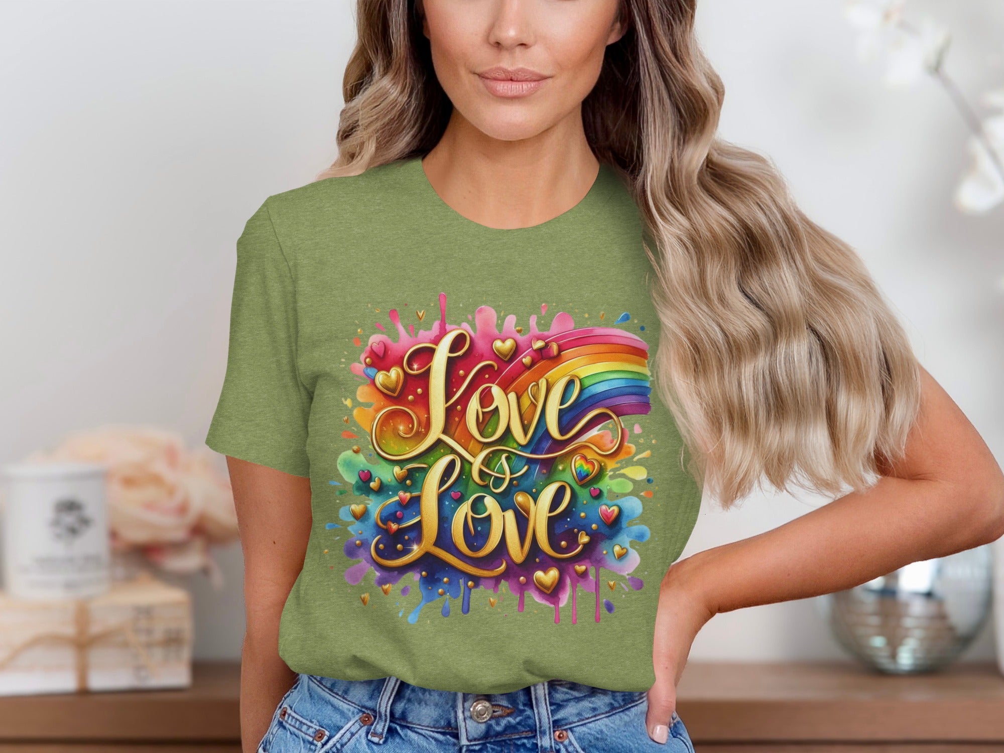 Green t-shirt with gold text "Love is Love" and rainbow watercolor splash.