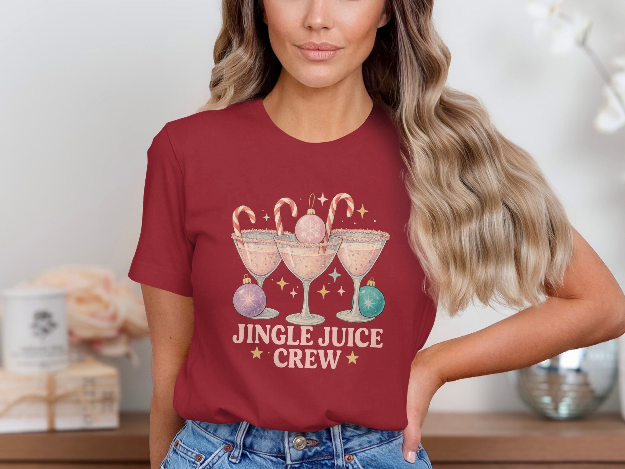 "Jingle Juice Crew" text with Christmas cocktail glasses and ornaments design on maroon t-shirt.