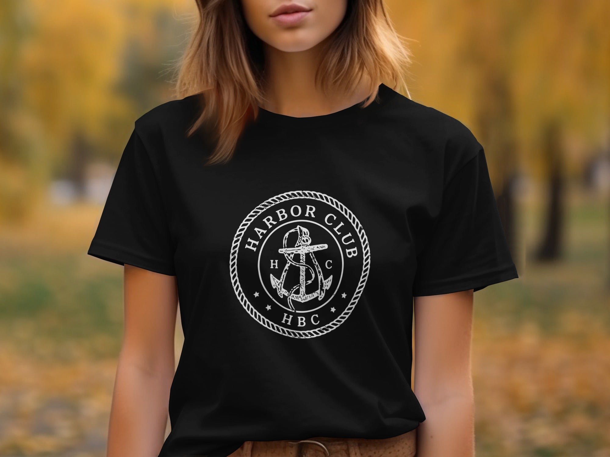Black t-shirt featuring a white circular emblem with an anchor, rope, and text "HARBOR CLUB HBC".