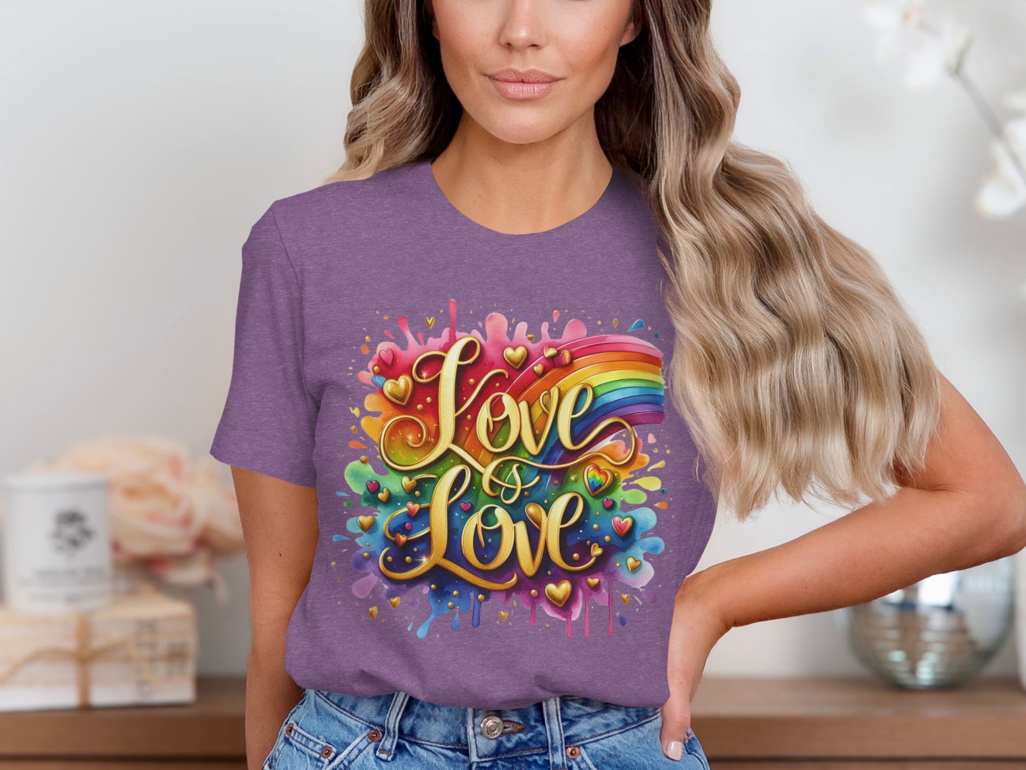 Purple t-shirt with gold lettering "Love is Love" and a colorful rainbow.