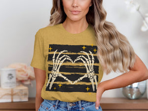 Yellow t-shirt with skeleton hands forming a heart on striped background.