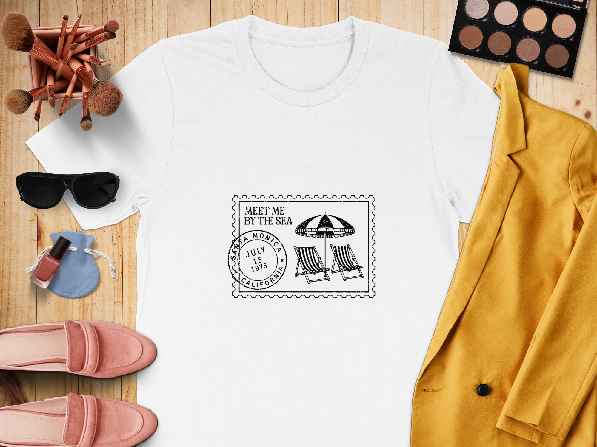 White t-shirt with "Meet Me By The Sea" stamp design featuring Santa Monica, California.